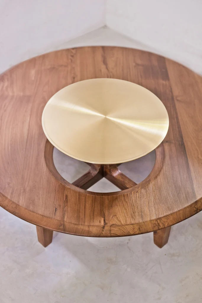 Alternative angle of the artisanal brass top furniture piece