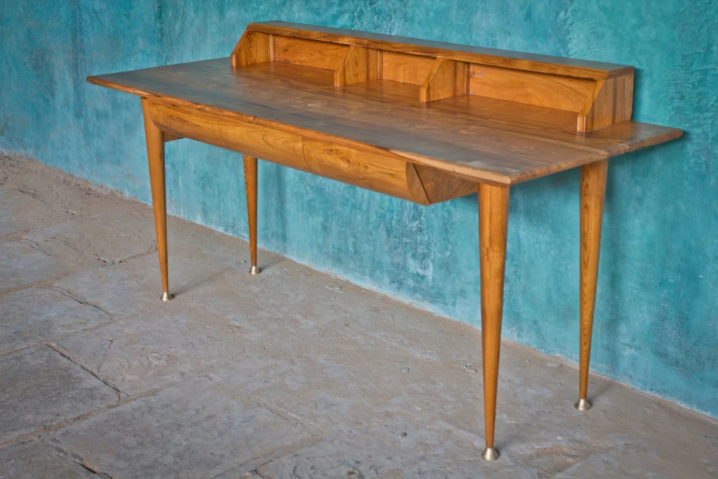 Modern work desk with capped legs set up in office space