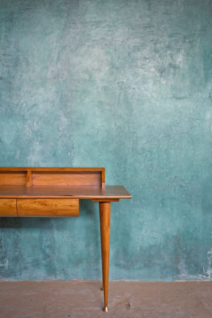 Close-up view of work desk with capped legs design